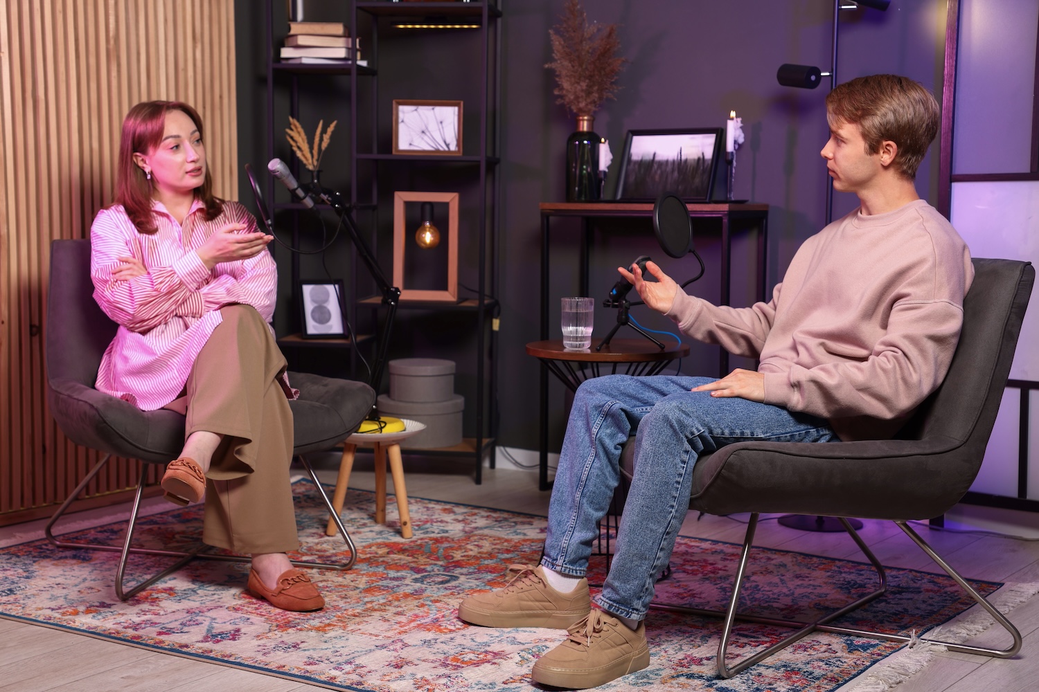 Podcast co-hosts recording talk show in studio